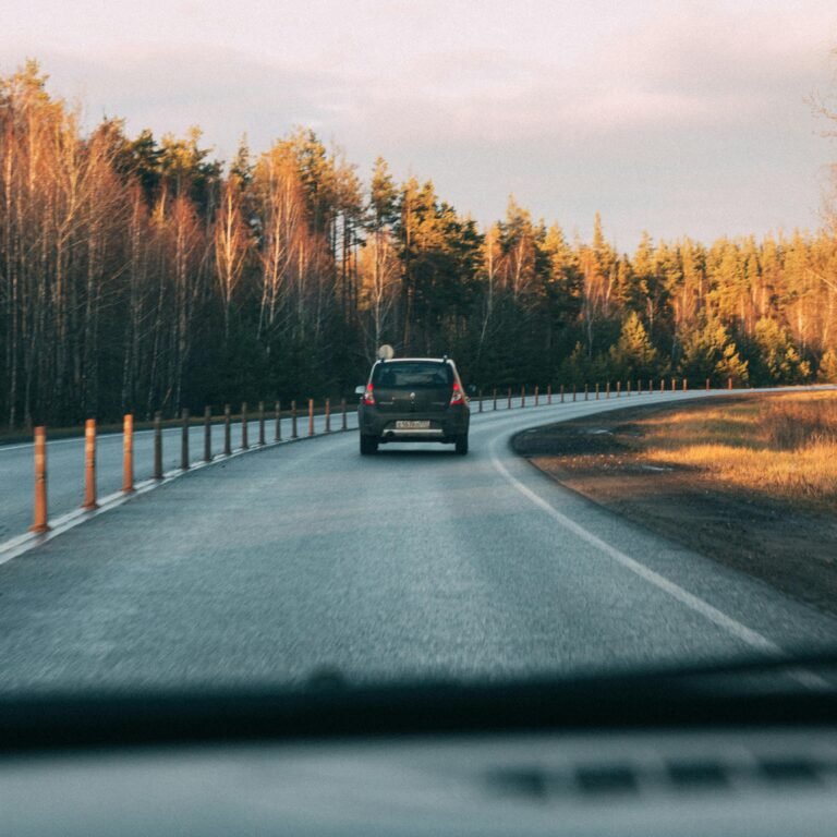 Black Car Travelling on Asphalt Road